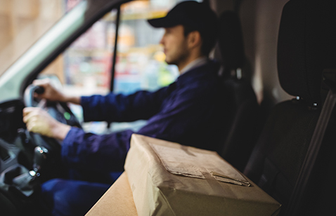 delivery driver driving with parcels on the front seat